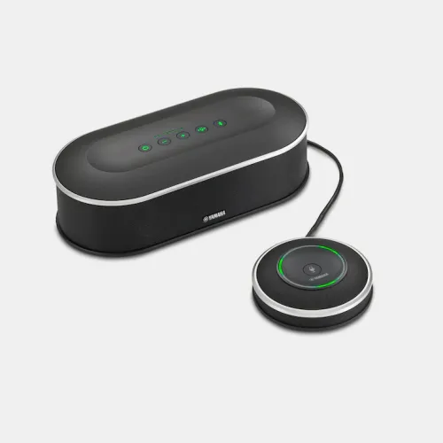A YVC-1000 Unified Microphone & Speaker, in black, features top touch controls on the speaker unit and is paired with a round wired microphone displaying a glowing green ring indicator. Both devices are shown against a plain light background.