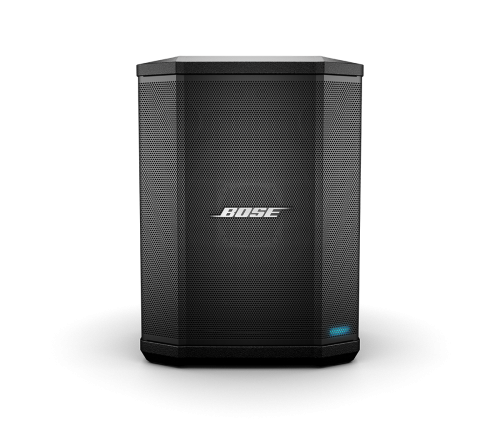 A black Bose S1 Pro Portable Bluetooth® Speaker System featuring a hexagonal shape, front-facing grille with the Bose logo centred, and a small blue indicator light at the bottom right. The premium design is highlighted within this versatile speaker system.