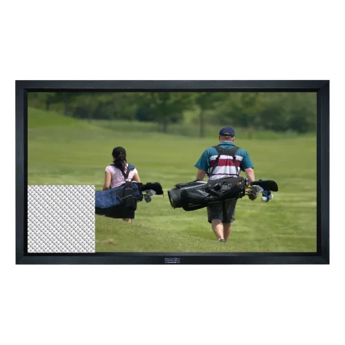 A man and woman carrying golf bags walk away across a grassy golf course, surrounded by greenery, on a sunny day.