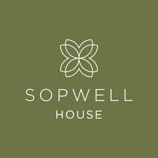 Olive green background with a white geometric flower-like design above the words SOPWELL HOUSE written in uppercase white letters, evoking the elegant atmosphere of this renowned St Albans cocktail bar.