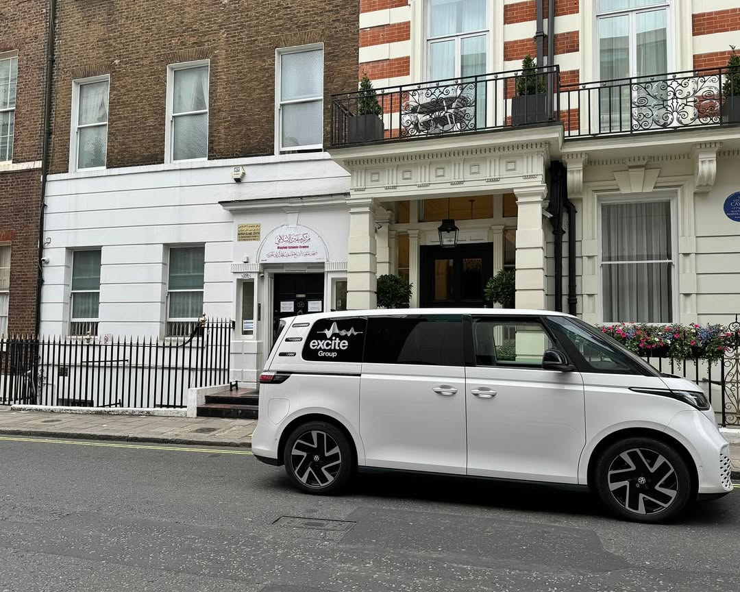 A white van with excite Group branding is parked on a quiet city street in front of classic brick and white buildings, not far from the elegant black iron railings and balconies of the Mayfair Islamic Centre. A white van with excite Group branding is parked on a quiet city street in front of classic brick and white buildings, not far from the elegant black iron railings and balconies of the Mayfair Islamic Centre.