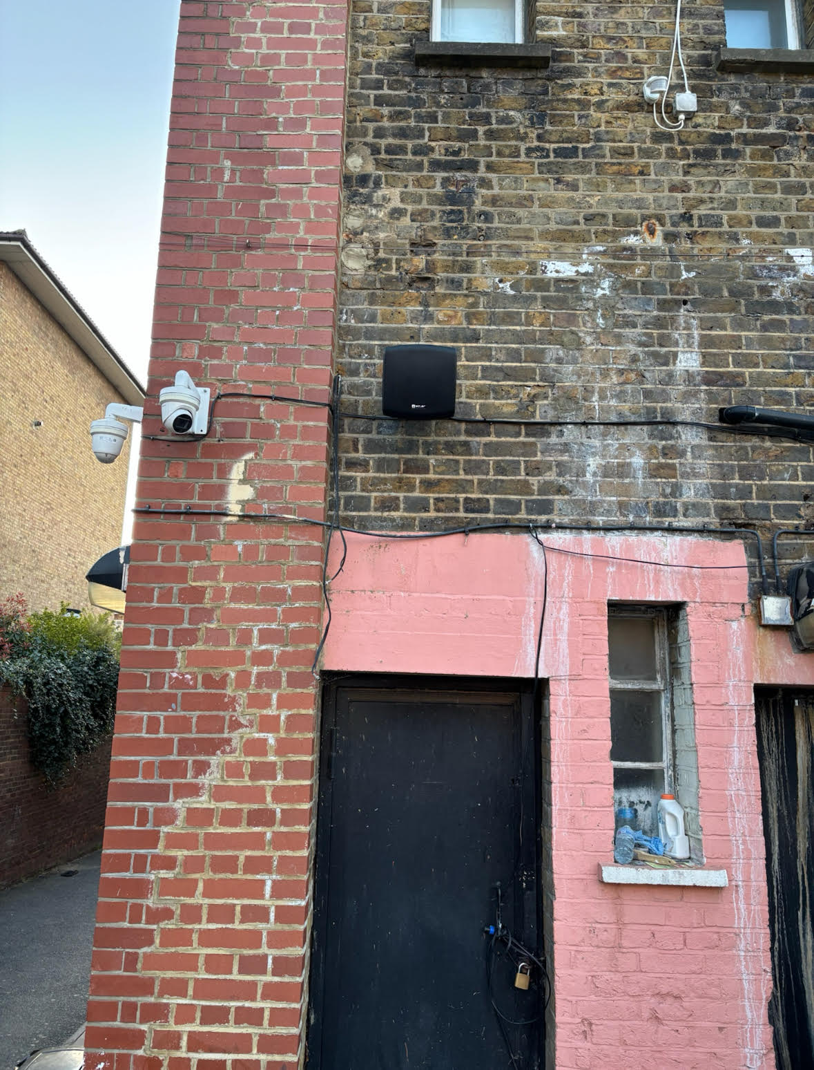 Outdoor speaker and CCTV camera on mosque facade Wall-mounted speaker and security camera installed on the exterior of EMCA Mosque