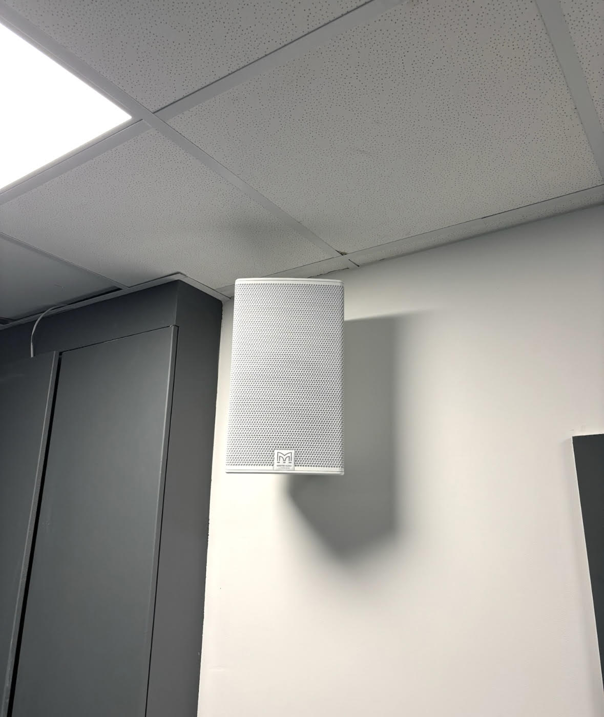 Vertical indoor speaker mounted near the ceiling Vertical column speaker fixed close to the ceiling inside EMCA Mosque hall